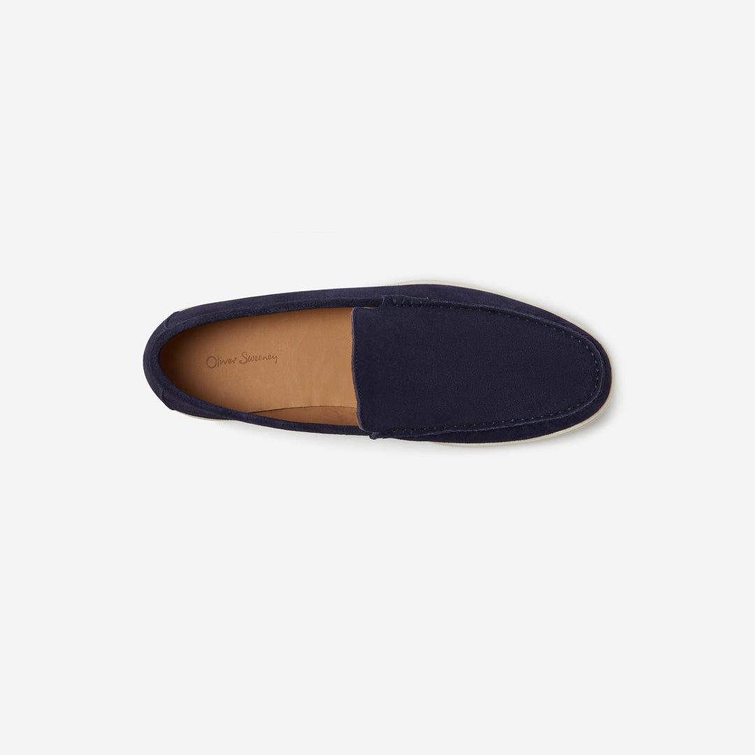 A single navy blue slip-on loafer shown from a top-down view on a light gray background. The shoe features a suede-like finish on the upper and a tan insole with 'Duck Shoes' printed in script. Oliver Sweeney Loafers available at Sakks Menswear in Southampton.