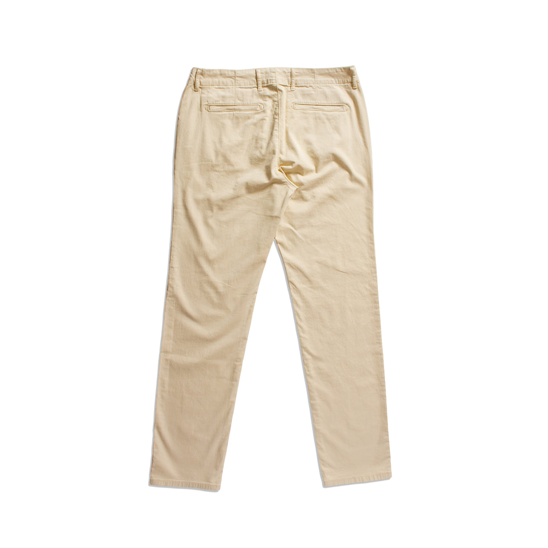 A pair of beige slim-fit pants shown from the back, featuring a button closure and belt loops, laid flat against a white background. PAIGE Chinos available at Sakks Menswear in Southampton.