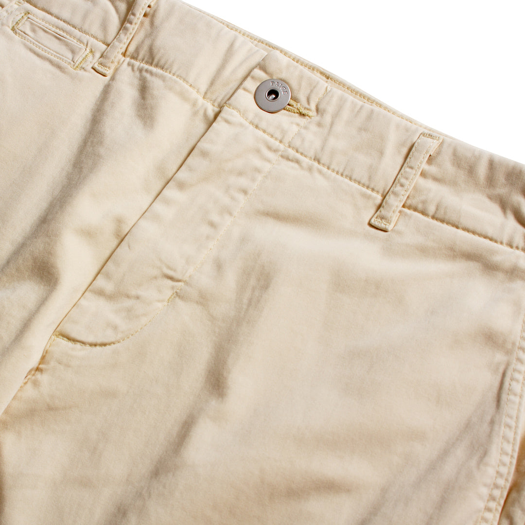 Close-up of beige chino pants showing the waistband, button closure, belt loops, and front pocket stitching against a white background. PAIGE Chinos available at Sakks Menswear in Southampton.