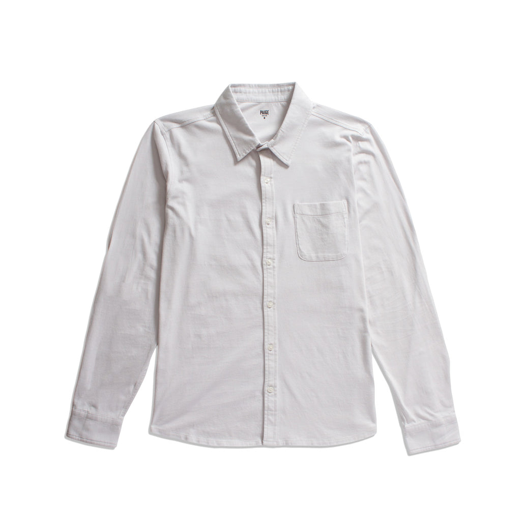 A white long-sleeve button-up shirt with a single chest pocket, laid flat against a solid white background. PAIGE Shirt available at Sakks Menswear in Southampton.