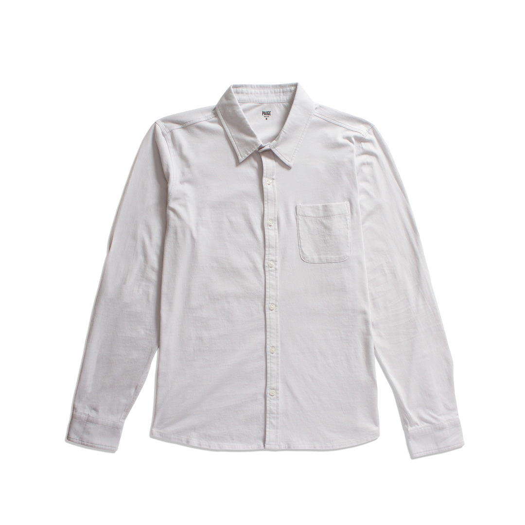 A white long-sleeve button-up shirt with a single chest pocket, laid flat against a solid white background. PAIGE Shirt available at Sakks Menswear in Southampton.