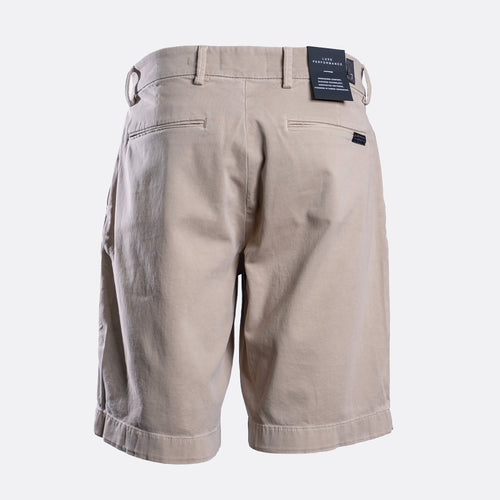 Back view of a pair of men's khaki shorts with a waistband belt loop, rear welt pockets, and a small black brand tag on the right side, shown on a light gray background. - 7 For All Mankind Comfort Sateen Chino Short in Mud. Sakks Menswear