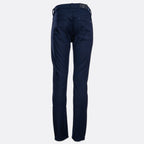 A pair of dark navy blue jeans shown from the waist down on a light grey background. 7 For All Mankind Slimmy Jeans. Sakks Menswear Southampton.