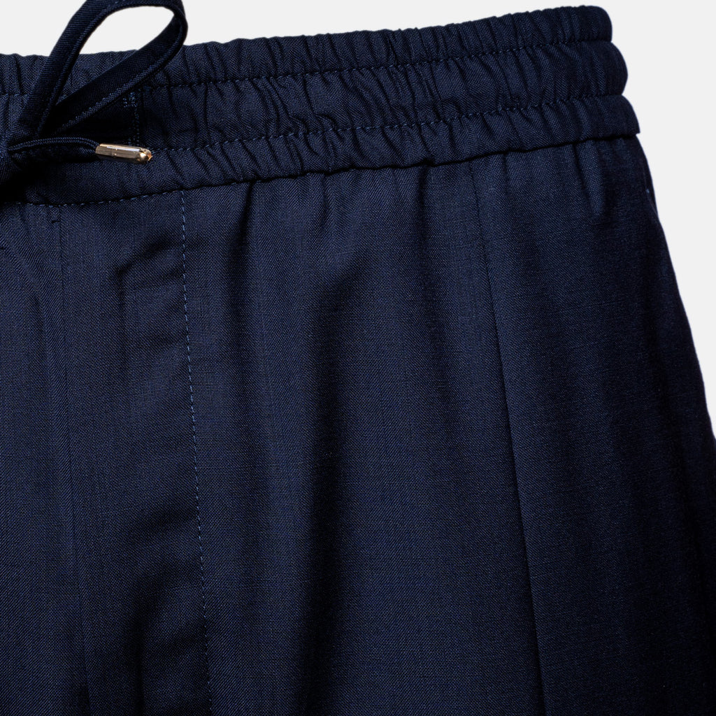 Close-up of dark navy blue trousers showing the elastic waistband, drawstring, and fabric texture against a light gray background. Briglia Trouser Sakks Menswear Southampton.