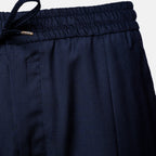 Close-up of dark navy blue trousers showing the elastic waistband, drawstring, and fabric texture against a light gray background. Briglia Trouser Sakks Menswear Southampton.