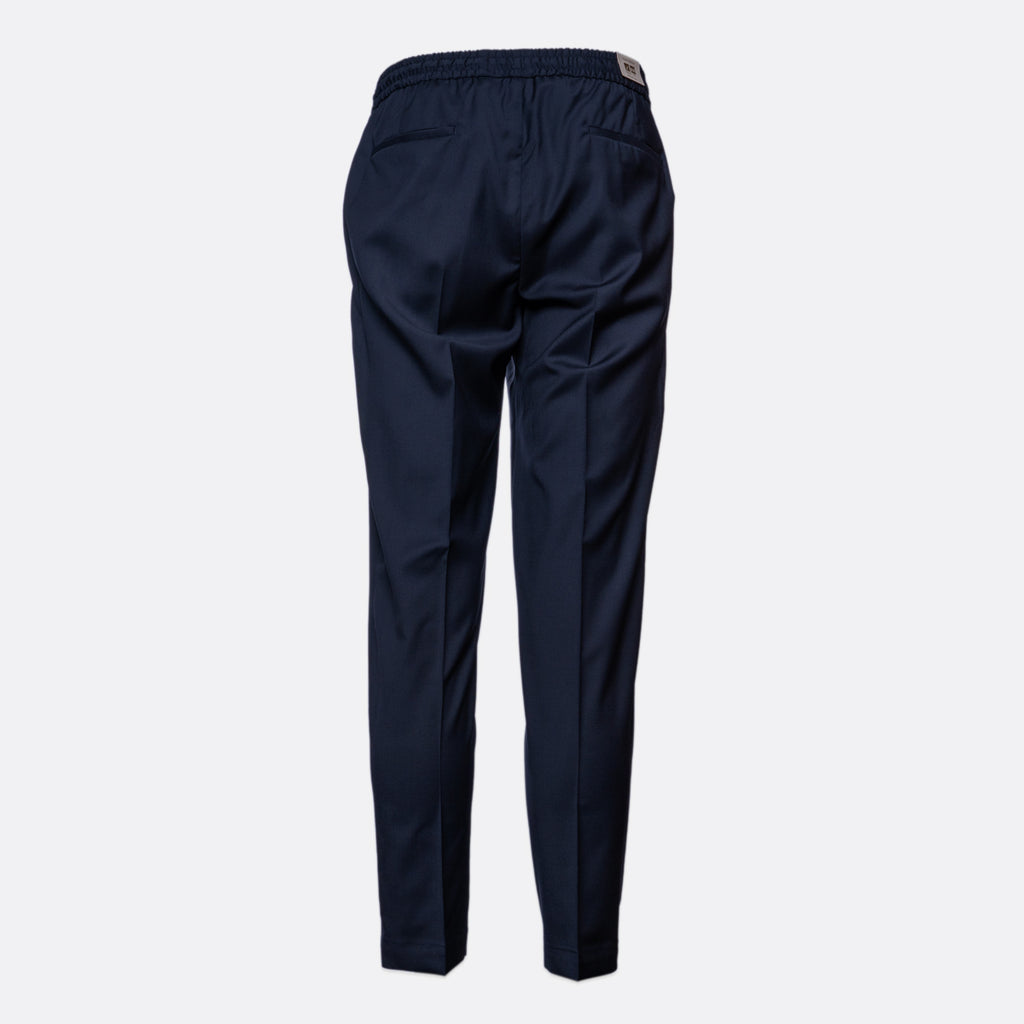 A pair of navy blue trousers shown from the back, featuring an elastic waistband and side pockets, displayed on a light gray background. Briglia Trouser Sakks Menswear Southampton.
