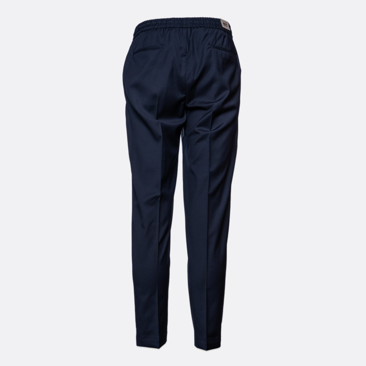 A pair of navy blue trousers shown from the back, featuring an elastic waistband and side pockets, displayed on a light gray background. Briglia Trouser Sakks Menswear Southampton.