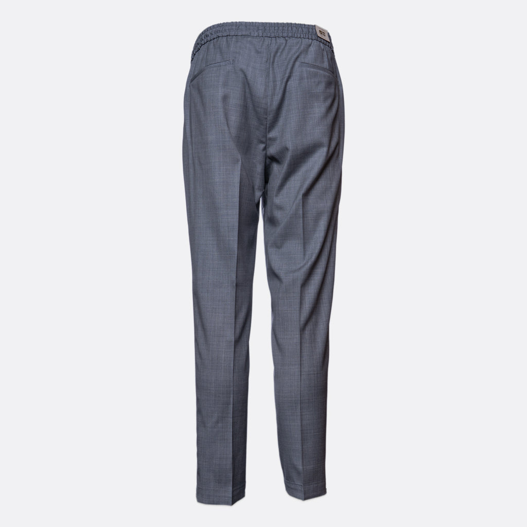 A pair of dark gray trousers shown from the back, featuring an elastic waistband and a subtle micro-check pattern, set against a plain light gray background. Briglia Trousers. Sakks Menswear Southampton.