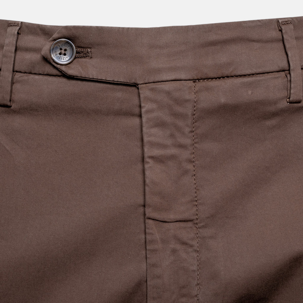Close-up of brown trousers showing the waistband, button closure, belt loops, and front seam details. Briglia Trousers. Sakks Menswear Southampton.