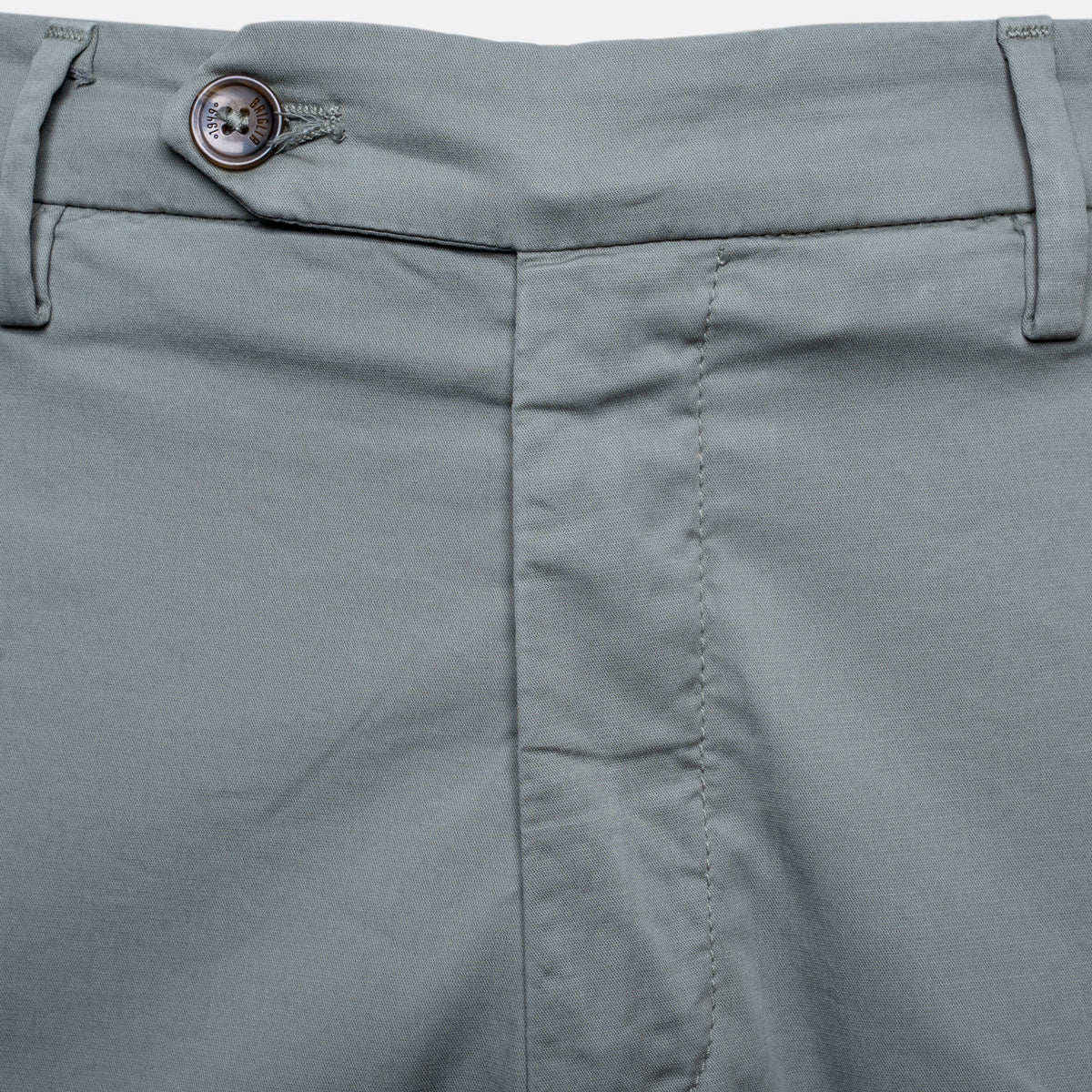 Close-up of the waistband of sage trousers, showing belt loops, a button closure, and front seam stitching. Briglia Trousers. Sakks Menswear Southampton.