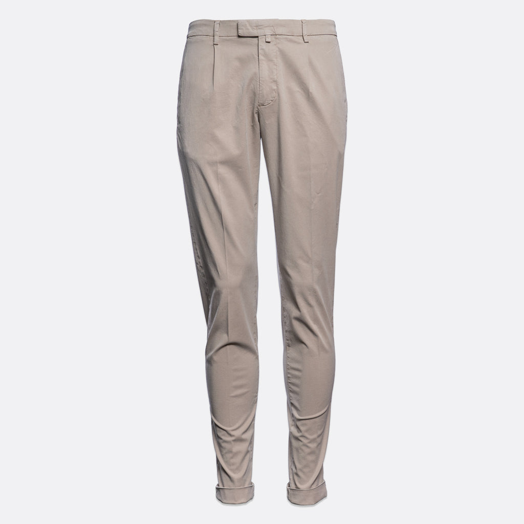 A pair of slim-fit chinos in a light taupe-beige colour, shown from the waist down on a solid light grey background. Briglia Trousers. Sakks Menswear Southampton.