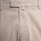 Close-up of light beige trousers showing the waistband, belt loops, front fly, and a side welt pocket. Briglia Trousers. Sakks Menswear Southampton.