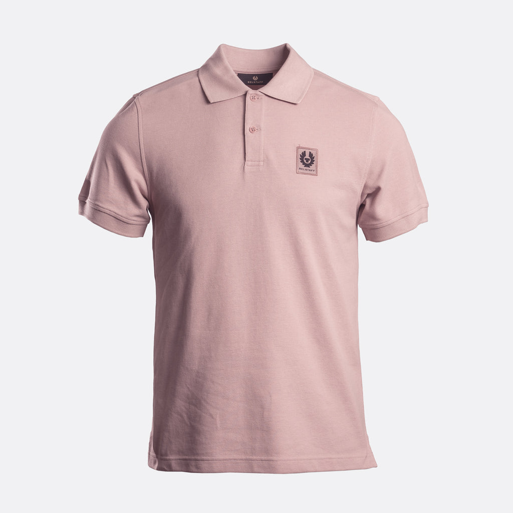 A light pink short-sleeve polo shirt with a small embroidered logo on the left chest, displayed on a clean white background. Belstaff Polo. Sakks Menswear Southampton.