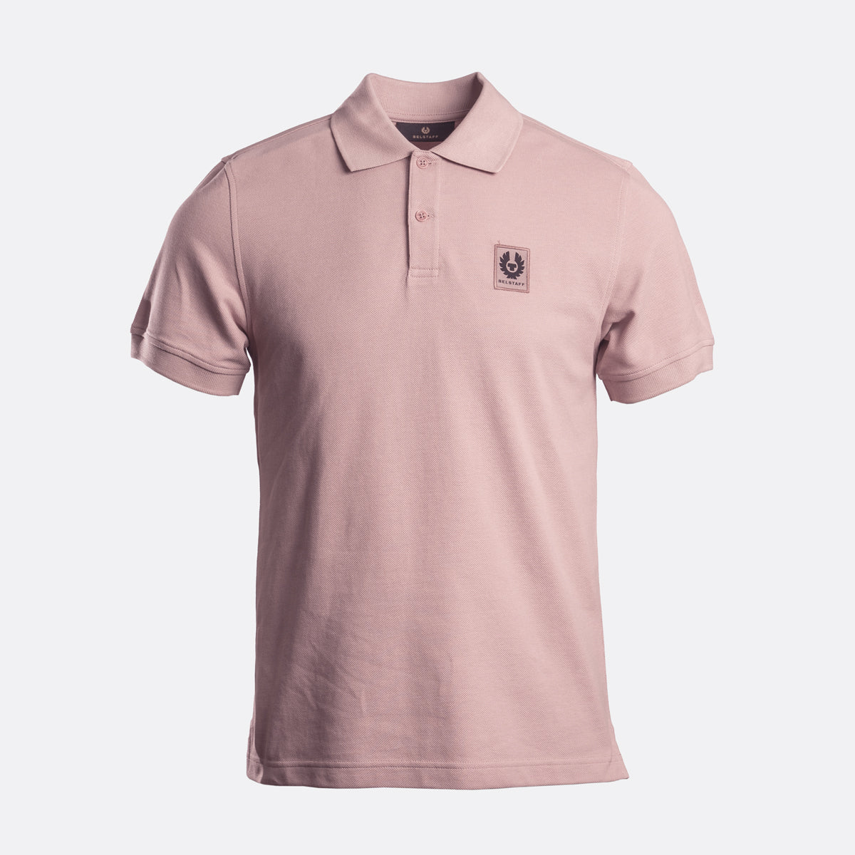 A light pink short-sleeve polo shirt with a small embroidered logo on the left chest, displayed on a clean white background. Belstaff Polo. Sakks Menswear Southampton.