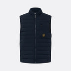 A dark navy blue quilted puffer vest with a stand-up collar, front zipper, and a vertical zippered chest pocket featuring a small yellow embroidered logo, shown against a light gray background. Belstaff Gilet. Sakks Menswear Southampton.
