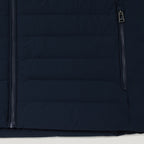 Close-up of a dark navy quilted puffer jacket showing a vertical front zipper and a smaller zippered pocket with a silver zipper pull. Belstaff Gilet. Sakks Menswear Southampton.