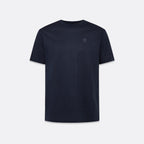 A dark navy blue short-sleeve crewneck t-shirt with a small tonal embroidered square logo on the left chest, displayed against a light gray background. Belstaff T-Shirt. Sakks Menswear Southampton.