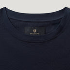 Close-up of a navy blue crewneck t-shirt showing the inner neck label with the BELSTAFF brand name and logo. Belstaff T-Shirt. Sakks Menswear Southampton.