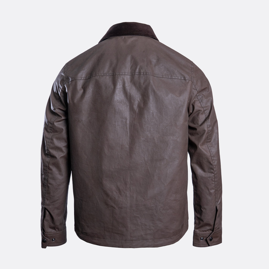 A dark brown waxed cotton jacket shown from the back, featuring a collar and long sleeves, photographed against a light gray background. Belstaff Jacket. Sakks Menswear Southampton.