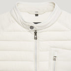 Close-up of a white puffer jacket with a stand-up collar, silver zipper, and a small visible GANT neck label. Belstaff Gilet. Sakks Menswear Southampton.