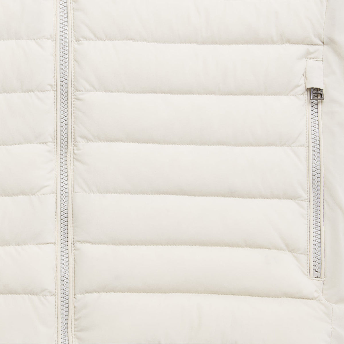 Close-up of a quilted puffer jacket in off-white, showing horizontal stitching, a front zipper, and a side zip pocket with a silver zipper pull. Belstaff Gilet. Sakks Menswear Southampton.