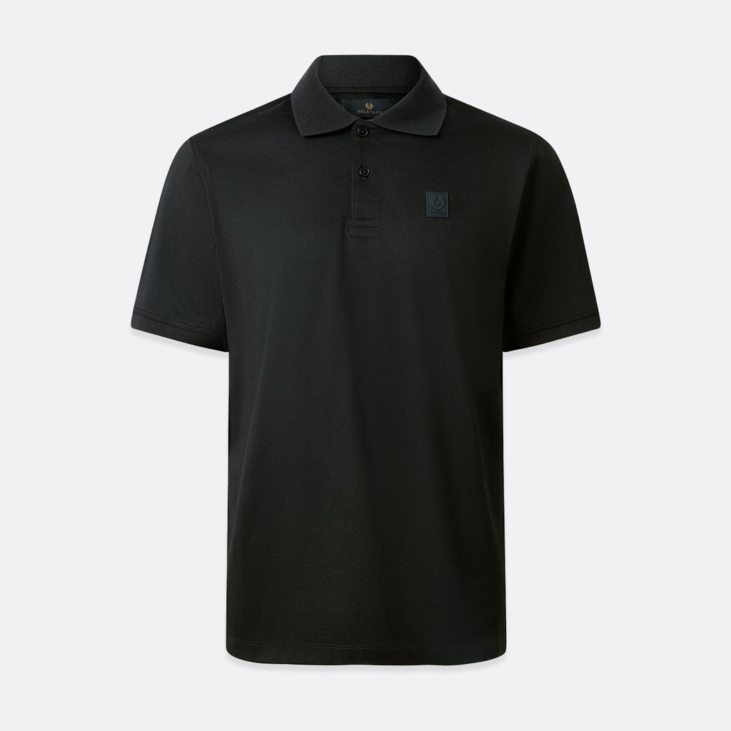 A black short-sleeve polo shirt with a small tonal square logo on the left chest, displayed on a clean light gray background. Belstaff Steel Polo. Sakks Menswear Southampton.