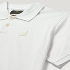 A close-up of a white short-sleeve polo shirt by Fred Perry, featuring a classic collar, two gold buttons, a black brand label at the inner neck, and a small white embroidered logo patch on the chest. Belstaff Polo. Sakks Menswear Southampton.