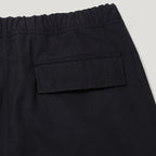 Close-up of black elastic-waist pants showing a side pocket and waistband detail against a light gray background. Belstaff Cargo Pants. Sakks Menswear Southampton.