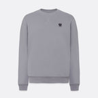 A light gray crewneck sweatshirt with a small black embroidered logo on the left chest, displayed on a clean light gray background. Belstaff Sweatshirt. Sakks Menswear Southampton.