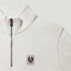 Close-up of a white quarter-zip pullover sweatshirt with a black zipper and a Belstaff logo patch on the chest. Belstaff Quarter Zip. Sakks Menswear Southampton.