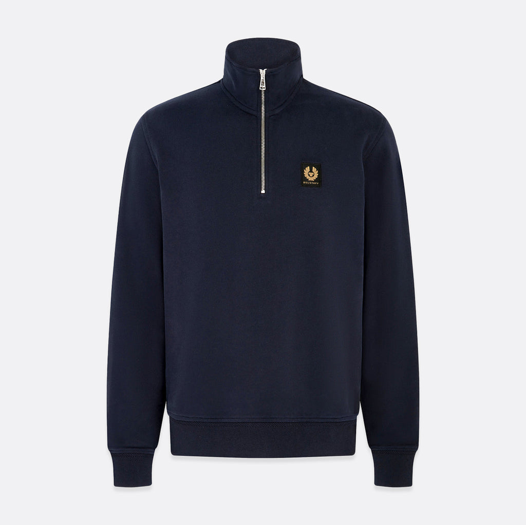 A navy blue quarter-zip sweatshirt with a small gold embroidered logo on the left chest, displayed on a light gray background. Belstaff Quarter Zip. Sakks Menswear Southampton.