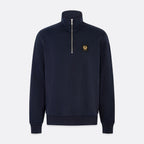 A navy blue quarter-zip sweatshirt with a small gold embroidered logo on the left chest, displayed on a light gray background. Belstaff Quarter Zip. Sakks Menswear Southampton.