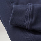 Close-up of a navy blue ribbed knit garment, showing the cuff and sleeve construction with fine fabric texture. Belstaff Quarter Zip. Sakks Menswear Southampton.