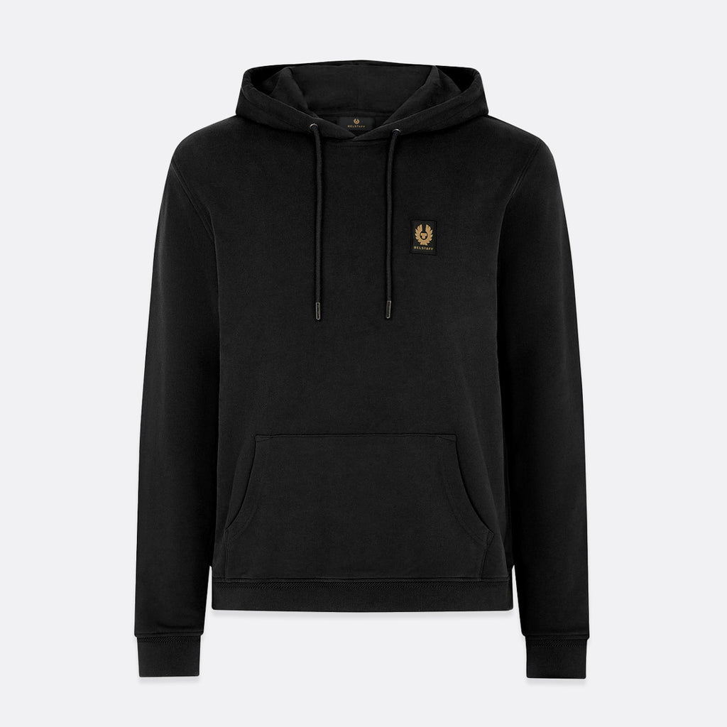A black pullover hoodie with a small embroidered gold crest logo on the left chest, displayed on a light gray background. Belstaff Hoodie. Sakks Menswear Southampton.