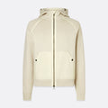 A cream-colored zip-up hoodie with a front zipper, kangaroo pockets with snap buttons, and a hood, shown against a light gray background. Belstaff Hoodie. Sakks Menswear Southampton.