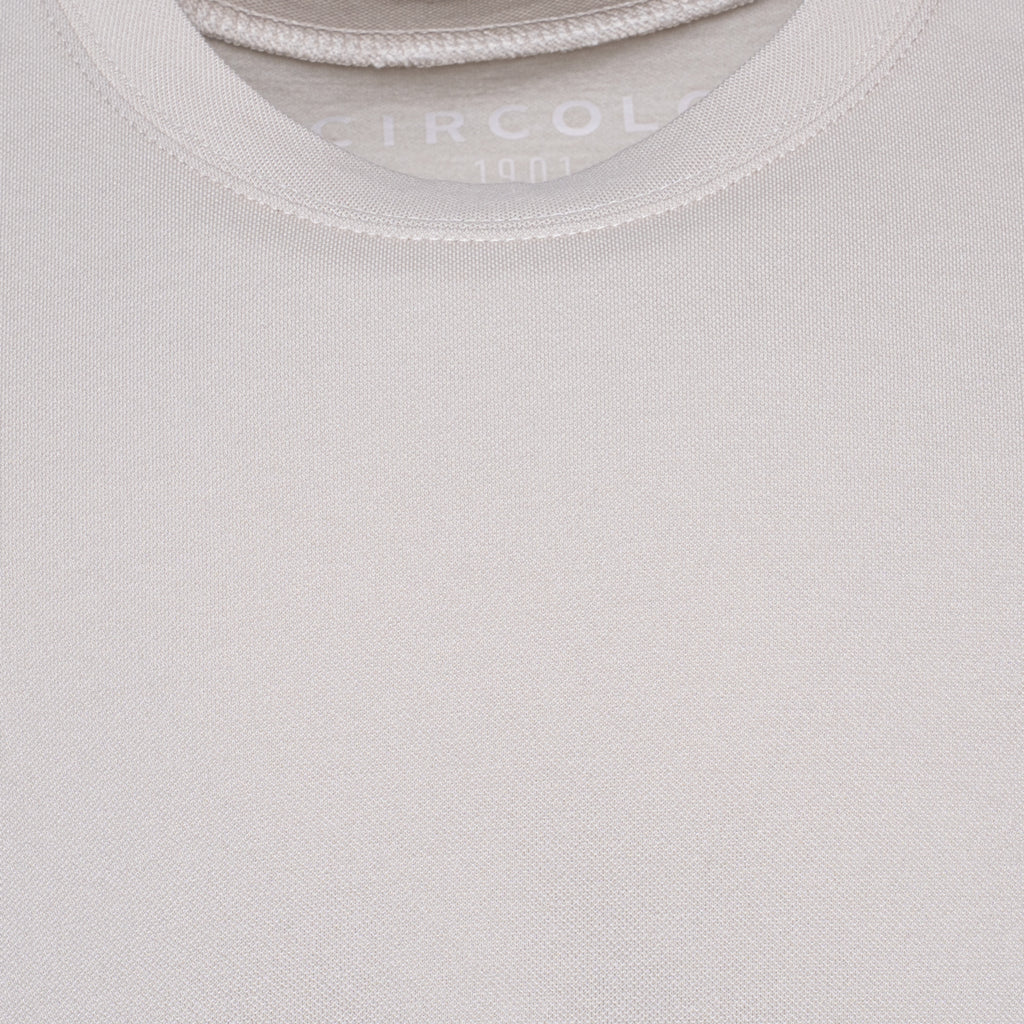 Close-up of a light beige crew-neck t-shirt showing the ribbed collar and the brand name 'CIRCOLO' printed inside. Circolo 1901 T-Shirt. Sakks Menswear Southampton.