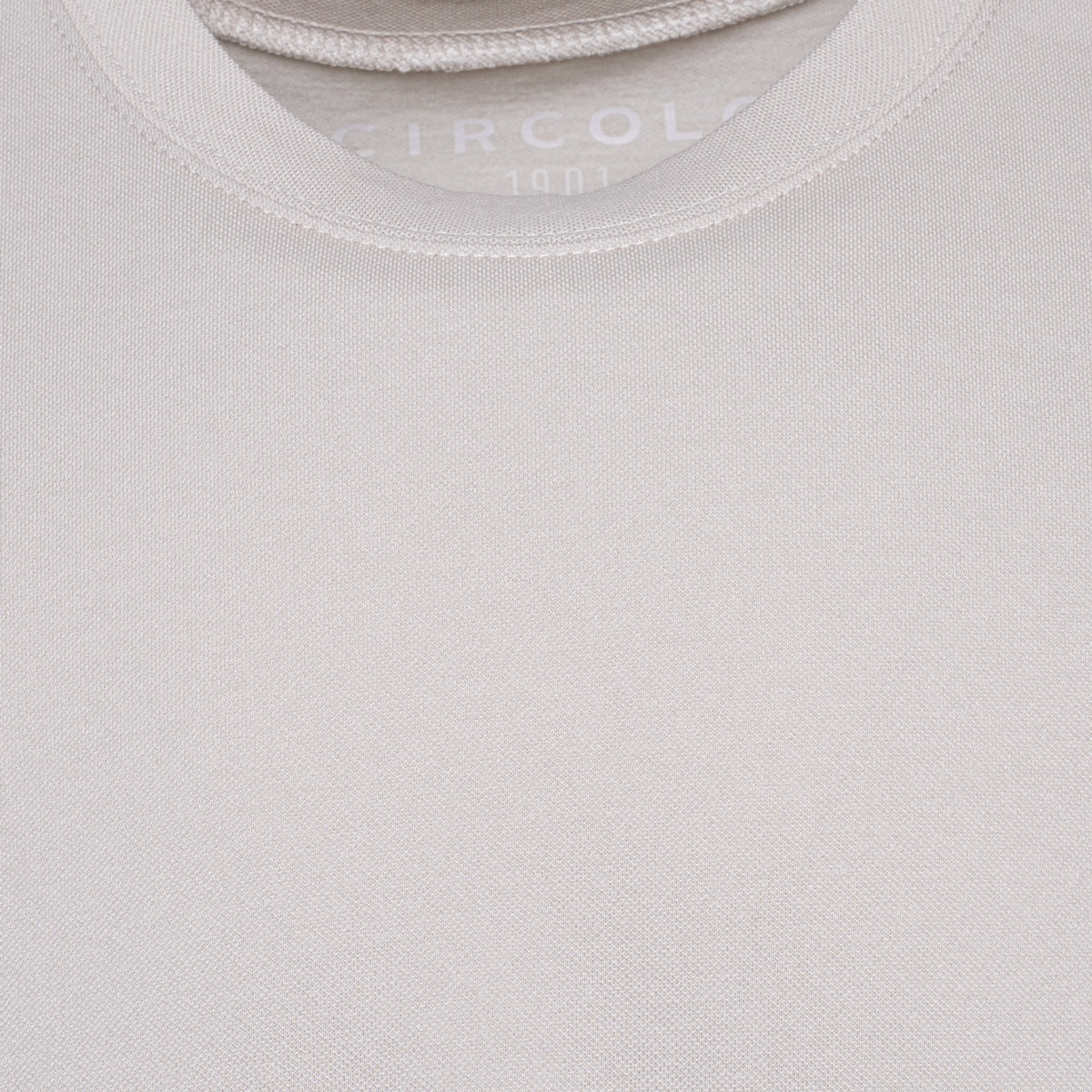 Close-up of a light beige crew-neck t-shirt showing the ribbed collar and the brand name 'CIRCOLO' printed inside. Circolo 1901 T-Shirt. Sakks Menswear Southampton.