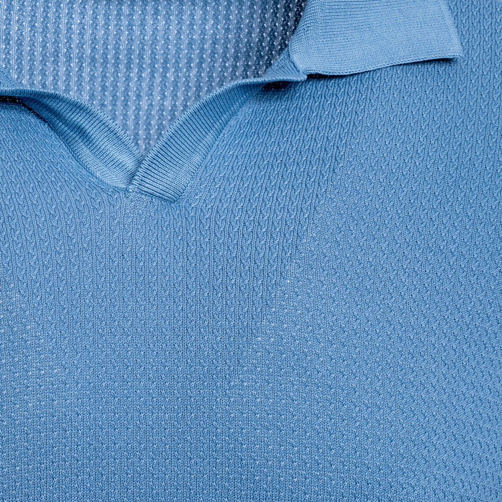 Close-up of a light blue knit polo shirt showing the textured fabric and collar detail. Circolo 1901 Polo Shirt. Sakks Menswear Southampton.