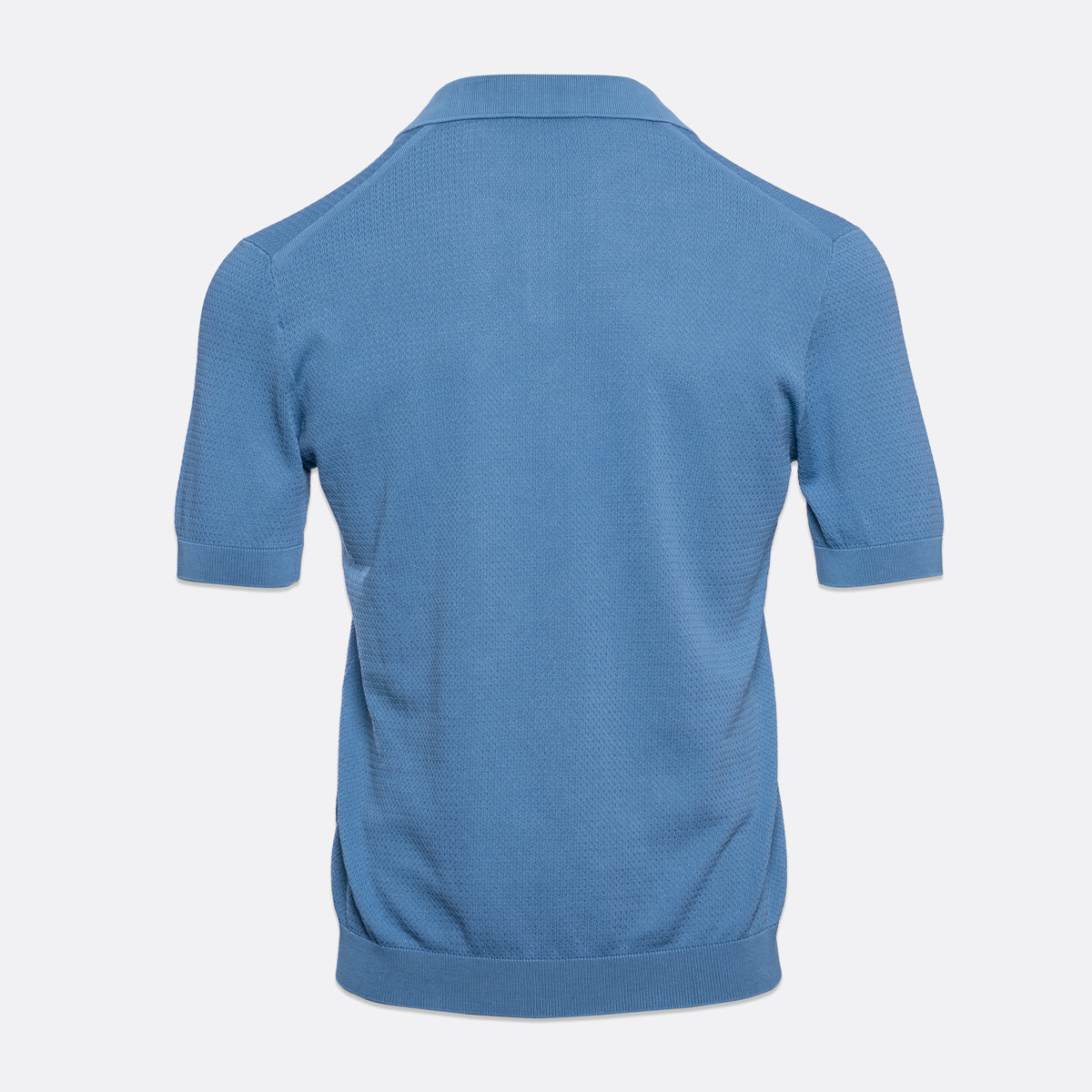 A light blue short-sleeve polo shirt shown from the back, featuring a textured knit fabric and ribbed collar, cuffs, and hem, set against a plain light grey background. Circolo 1901 Polo Shirt. Sakks Menswear Southampton.