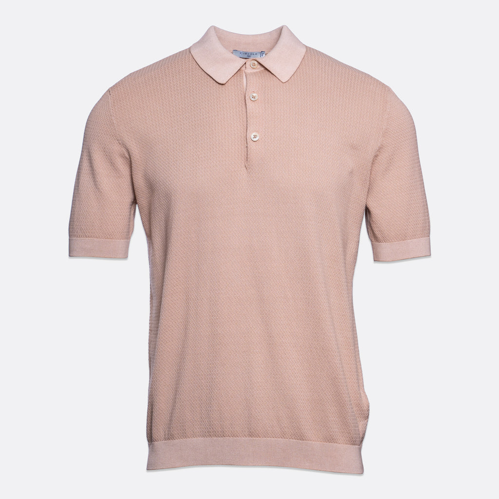 A short-sleeve polo shirt in a dusty rose pink colour, featuring a textured knit fabric, a classic collar, and a two-button placket, shown against a plain light grey background. Circolo 1901 Polo. Sakks Menswear Southampton.