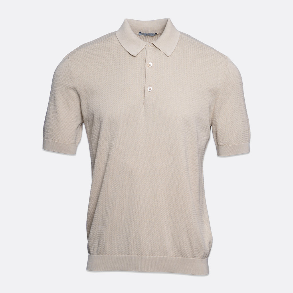 A short-sleeve polo shirt in a light beige or cream colour, featuring a textured knit fabric, a classic collar, and a two-button placket, shown against a plain light grey background. Circolo 1901 Polo. Sakks Menswear Southampton.