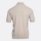 A light beige short-sleeve polo shirt shown from the back, featuring a textured knit fabric and a classic collar, set against a plain light grey background. Circolo 1901 Polo. Sakks Menswear Southampton.
