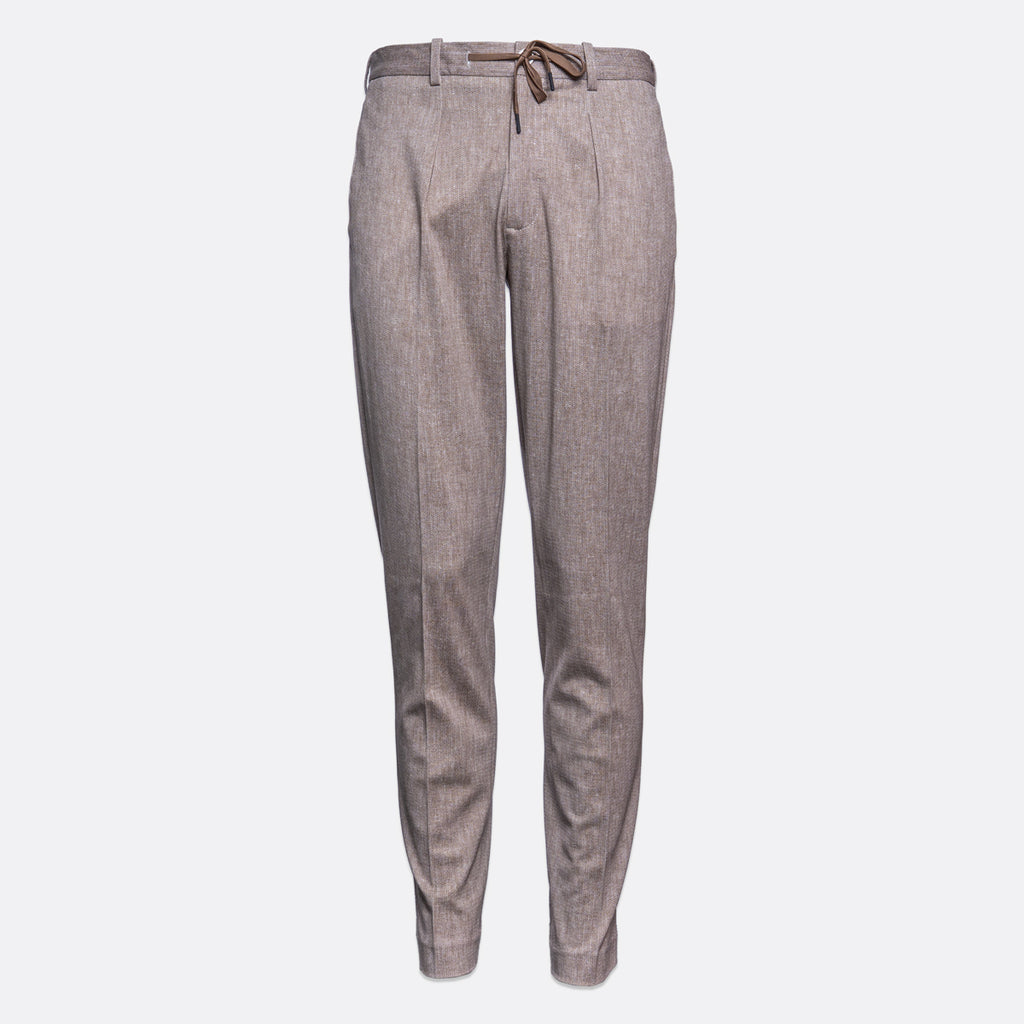 A pair of men's slim-fit trousers in a textured taupe-gray fabric, featuring a drawstring waistband and front creases, shown against a plain light gray background. Circolo 1901 Trousers. Sakks Menswear Southampton.