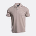 A short-sleeve polo shirt in taupe with white contrast piping on the collar and sleeve cuffs, featuring a two-button placket and a small white embroidered eagle logo on the left chest. The shirt is displayed on a clean, light grey background. Emporio Armani Polo. Sakks Menswear Southampton.