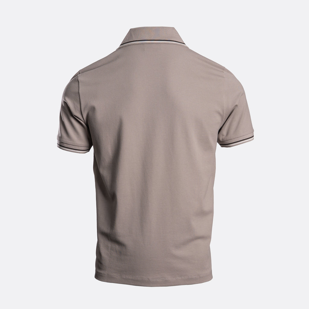 A short-sleeve polo shirt shown from the back, featuring a solid taupe-brown colour with thin white stripe accents on the collar and sleeve cuffs, set against a light grey background. Emporio Armani Polo. Sakks Menswear Southampton.