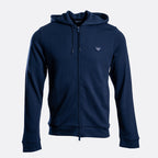 A navy blue zip-up hoodie with a drawstring hood and a small embroidered logo on the left chest, displayed against a light gray background. Emporio Armani Hoodie. Sakks Menswear Southampton.