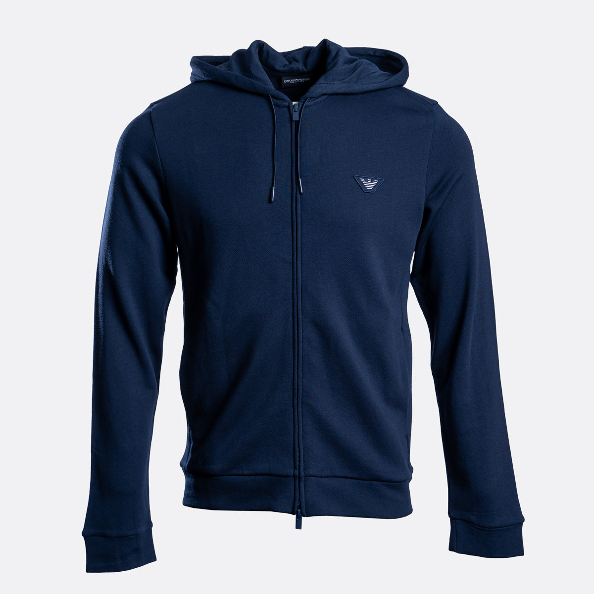 A navy blue zip-up hoodie with a drawstring hood and a small embroidered logo on the left chest, displayed against a light gray background. Emporio Armani Hoodie. Sakks Menswear Southampton.