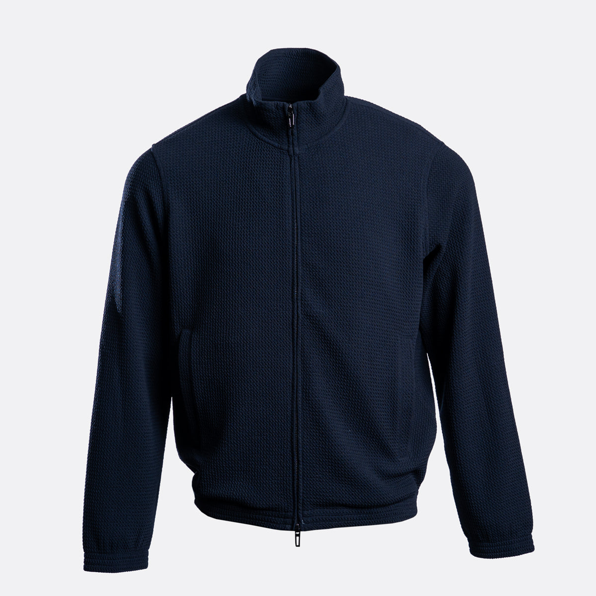 A dark navy blue waffle-knit zip-up jacket with a stand-up collar, displayed on a light gray background. Emporio Armani Sweatshirt. Sakks Menswear Southampton.