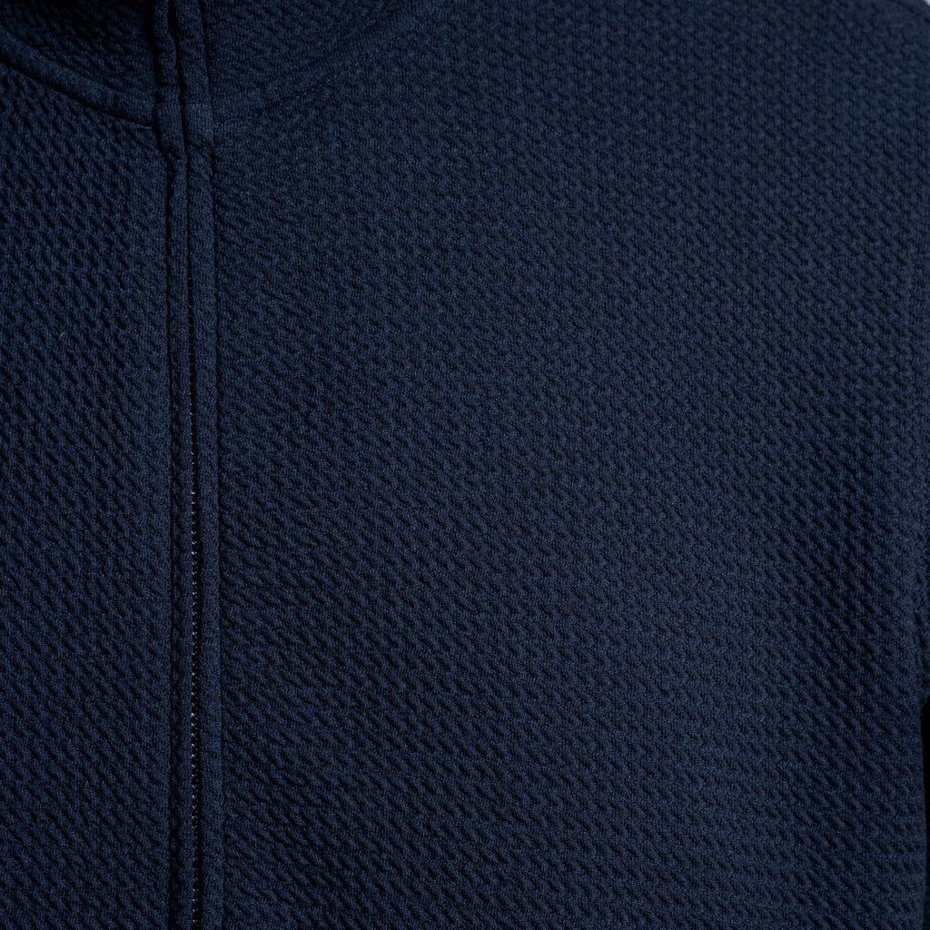 Close-up of a dark navy blue textured zip-up garment, showing the fabric weave and zipper detail. Emporio Armani Sweatshirt. Sakks Menswear Southampton.