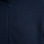 Close-up of a dark navy blue textured zip-up garment, showing the fabric weave and zipper detail. Emporio Armani Sweatshirt. Sakks Menswear Southampton.